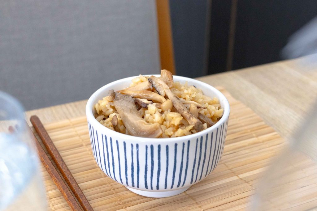 A bowl of Japanese Mushroom Rice (Kinoko Gohan) on a table.