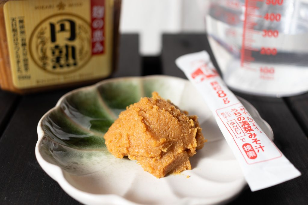 a dollop of Miso paste on a plate with Dashi powder on the side to make Miso Soup with Dashi powder.