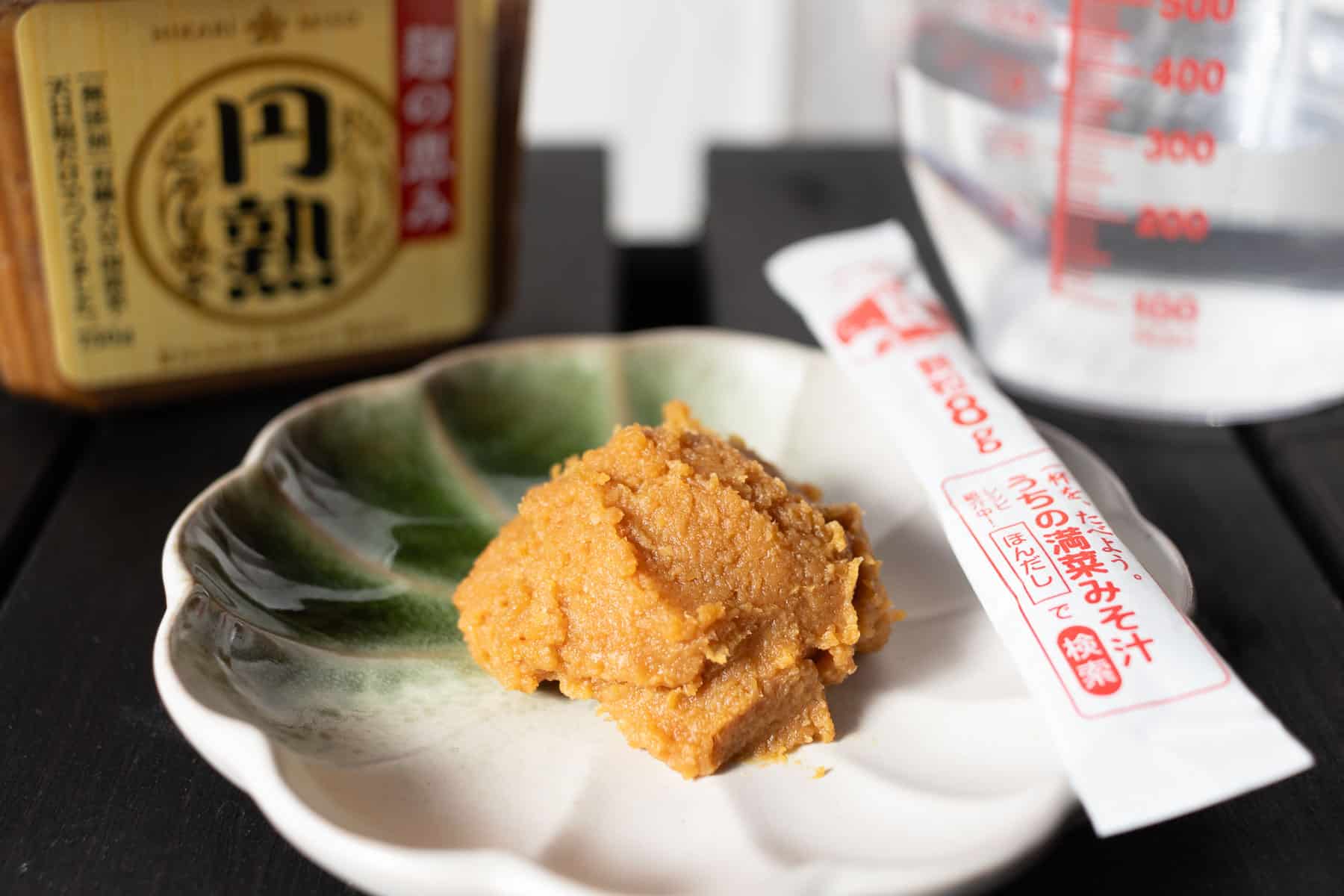 a dollop of Miso paste on a plate with Dashi powder on the side to make Miso Soup with Dashi powder.