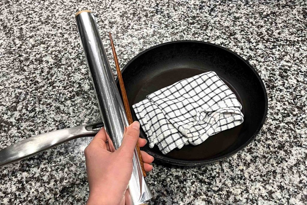 Equipment needed for making an Otoshibuta. Aluminium foil, chopstick, dish towel and a pot/pan.