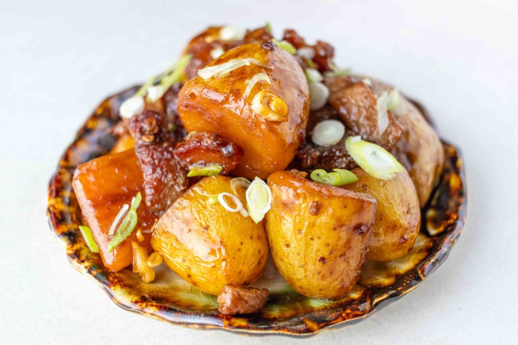 Japanese Pork and Potato (Nikkujaga) on a small side dish plate.