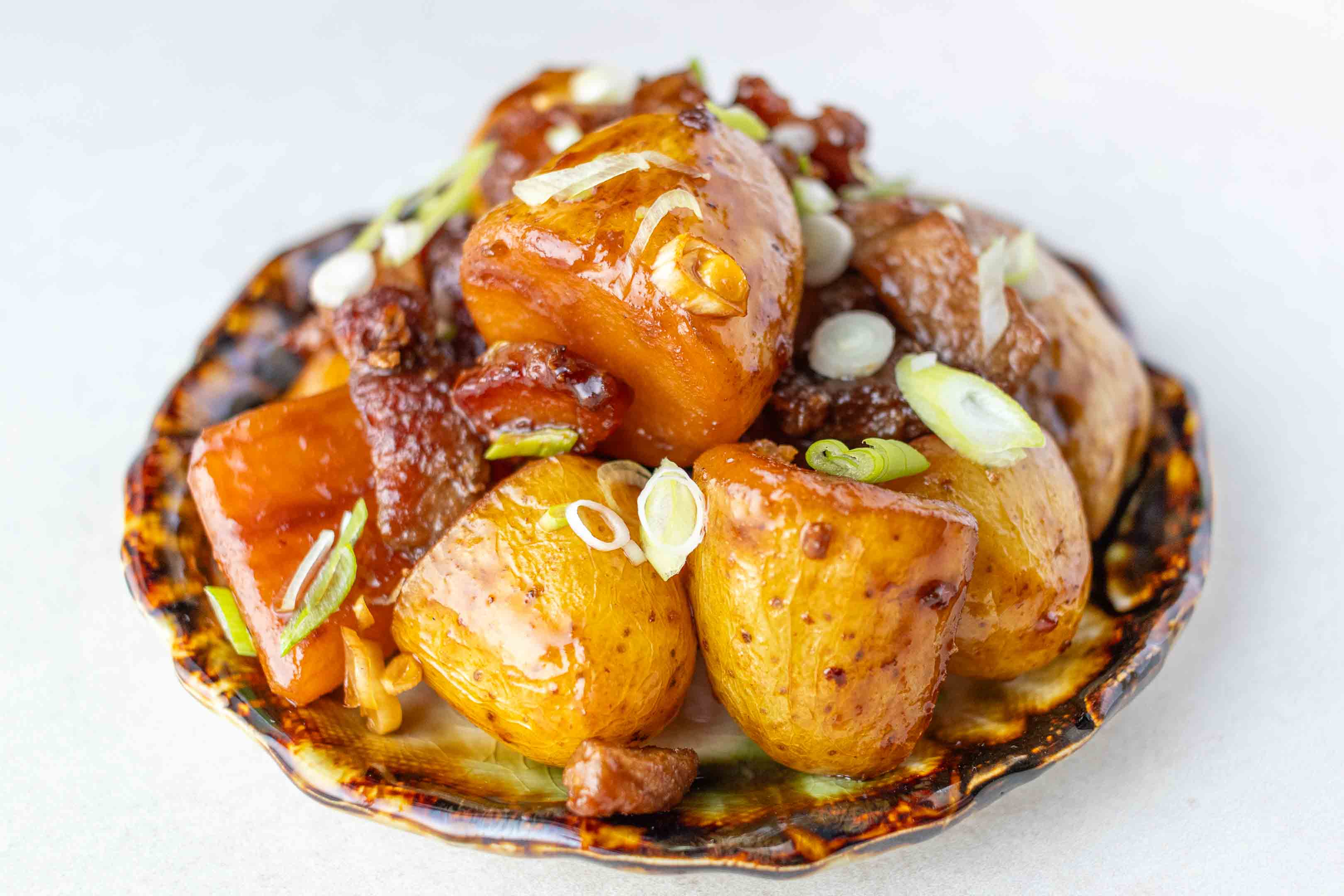 Japanese Pork and Potato (Nikkujaga) on a small side dish plate.