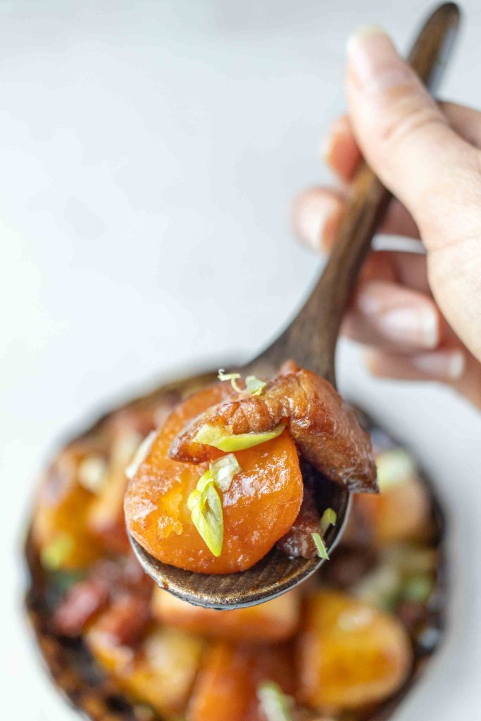 Japanese Pork and Potato (Nikkujaga) on a wooden spoon.