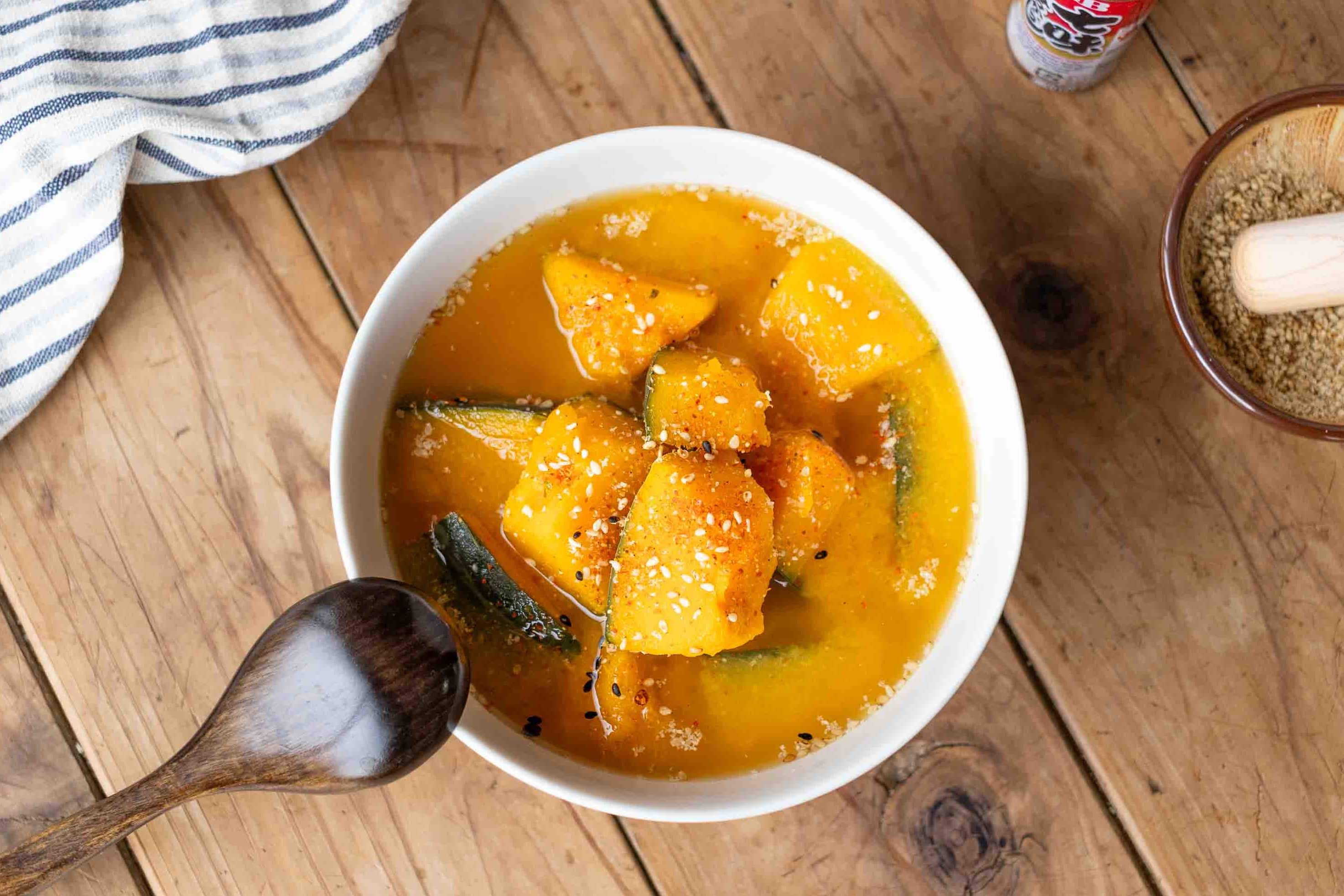 A bowl of Kabocha Miso Soup with Shichimi, a Japanese seven spice mixture, sprinkled on top.