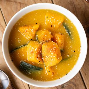 A bowl of Kabocha Miso Soup with Shichimi, a Japanese seven spice mixture, sprinkled on top.