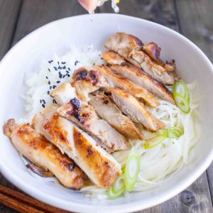 A bowl of easy Japanese fried chicken on a bed of rice with black sesame seeds.