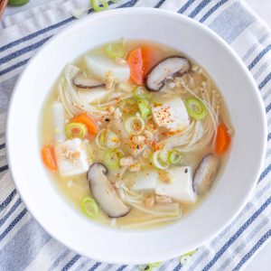 A bowl of Natto Jiru (Natto Miso Soup) with green onions and shichimi sprinkled on top.