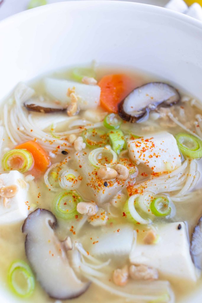 A bowl of Natto Jiru (Natto Miso Soup) with green onions and shichimi sprinkled on top.