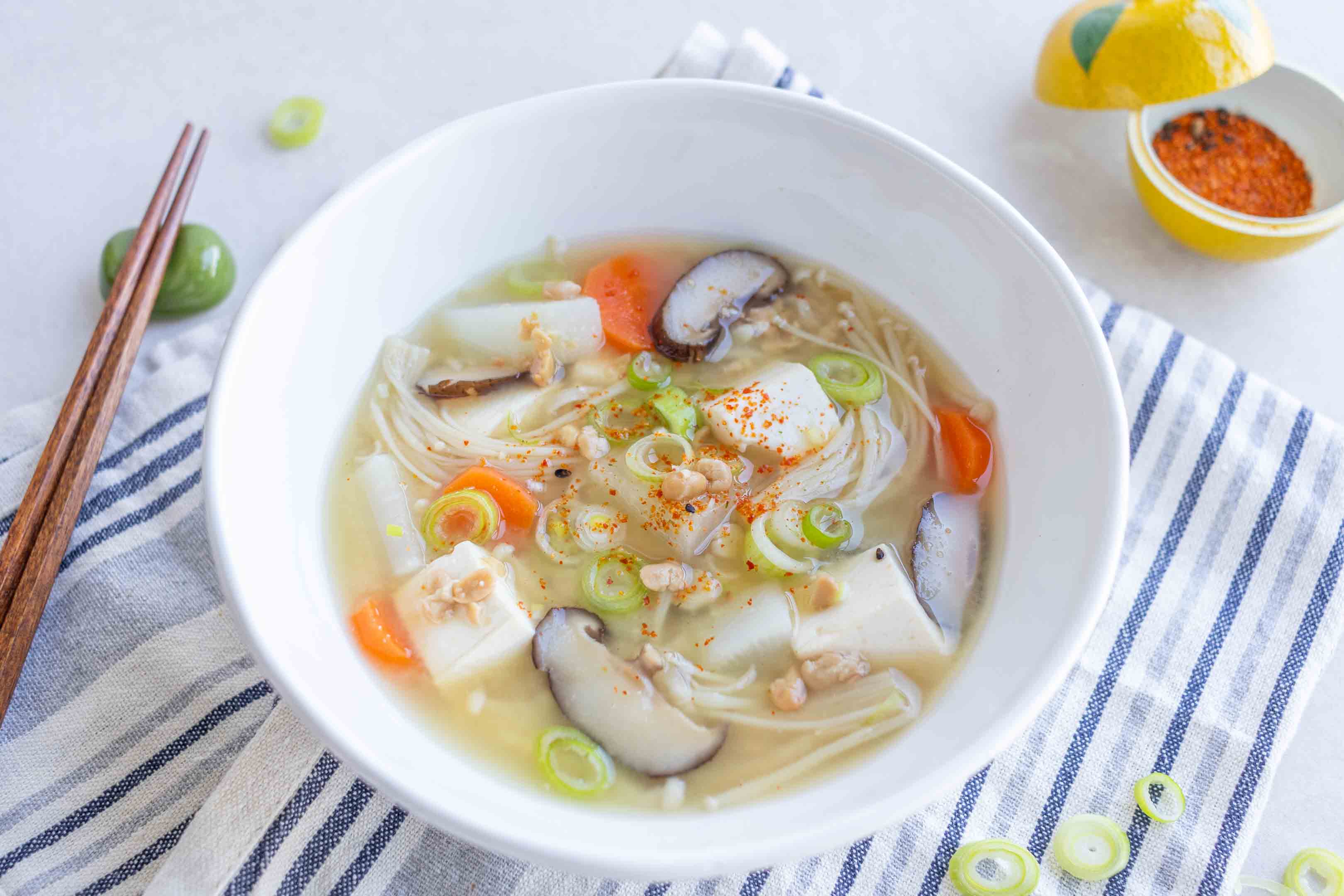 A bowl of Natto Jiru (Natto Miso Soup) with green onions and shichimi sprinkled on top.