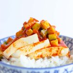 A bowl of cold kimchi tofu spooned over white rice.