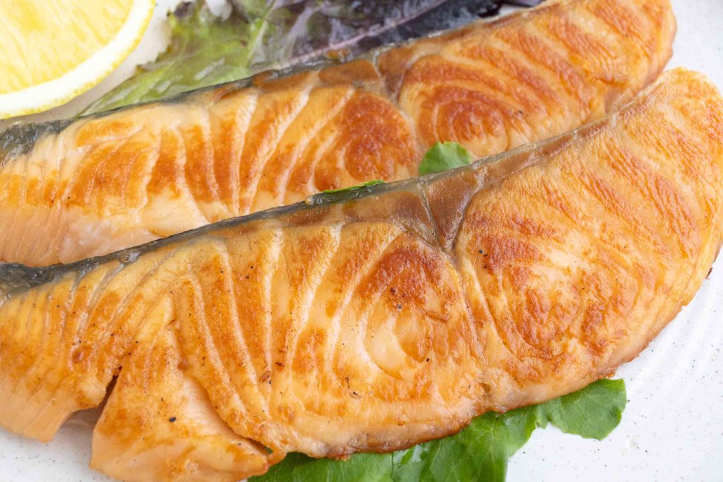 a plate with two fillets of shiozake (Japanese salted salmon)