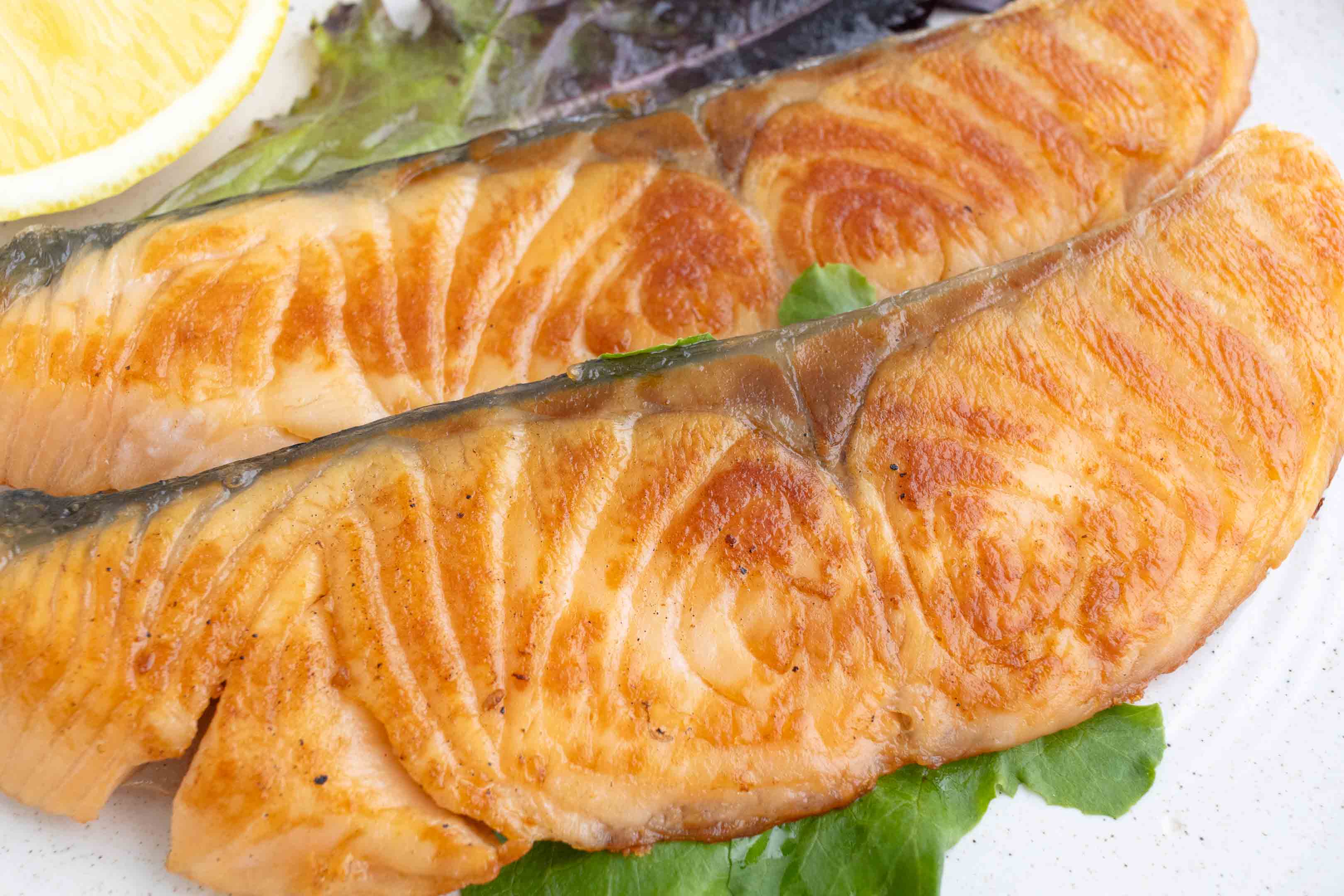 a plate with two fillets of shiozake (Japanese salted salmon)